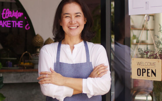 Photo of a small business owner in front of her shop