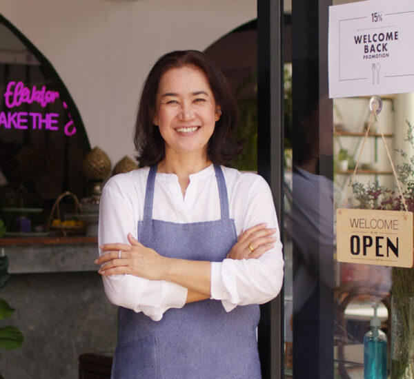 Photo of a small business owner in front of her shop