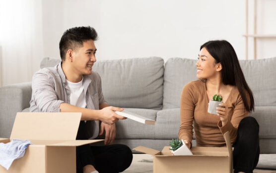 Photo of a young couple unpacking boxes