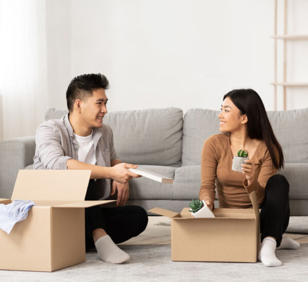 Photo of a young couple unpacking boxes