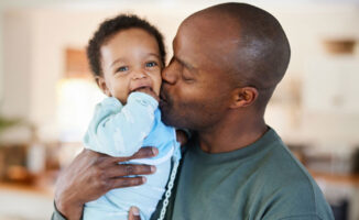 Photo of a father holding a child