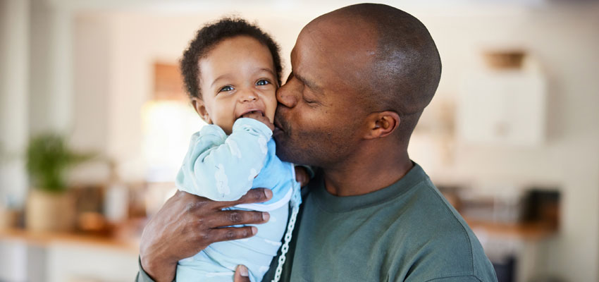 Photo of a father holding a child