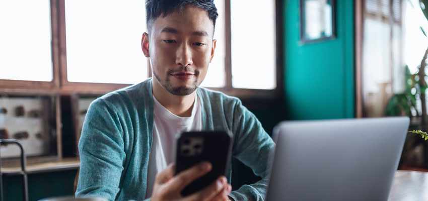 Image of a man checking information on his phone